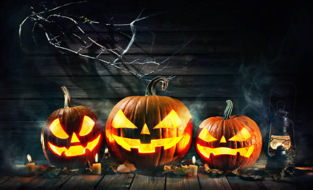 istock Halloween pumpkin head jack lantern with burning candles 1168441673
