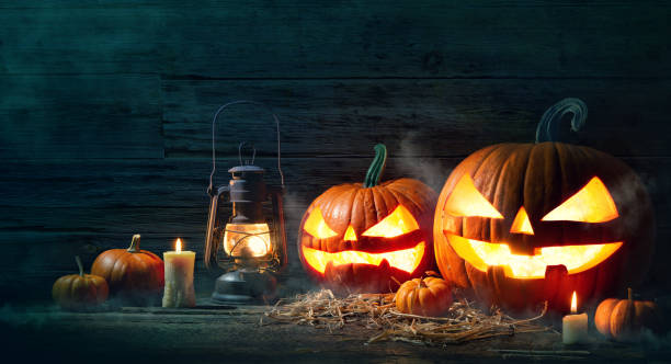 istock Halloween pumpkin head jack lantern with burning candles 1168441682