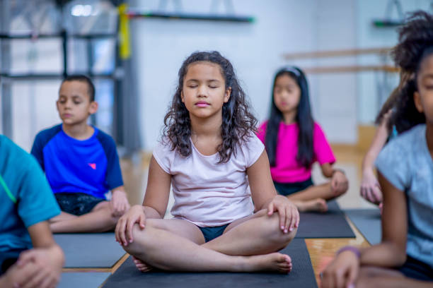 Kids' yoga class Multi-ethnic group of kids in fitness class together. mindfulness children stock pictures, royalty-free photos & images