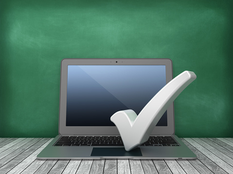 Laptop with Check Mark on Chalkboard Background - 3D Rendering