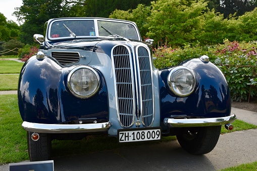 Juechen, Germany - August 2, 2019: BMW 327 / 328 Cabriolet from 1938. The car is on display during the 2019 Classic Days at castle Dyck. The car is displayed in a park, with people looking at the cars in the background.