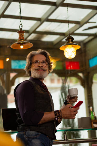 istock Cafe visitor smiling to a waiter passing by. 1168444315