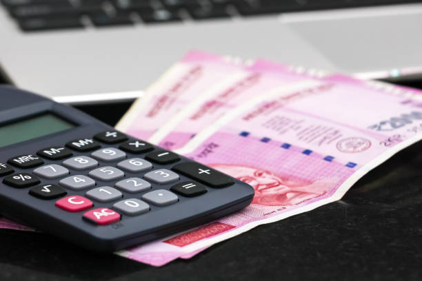 istock new indian 2000 rupees banknotes, electronic calculator and  laptop. 1168444818
