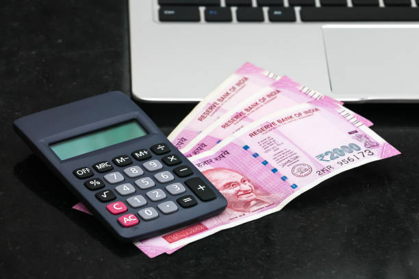 istock new indian 2000 rupees banknotes, electronic calculator and  laptop. 1168444848