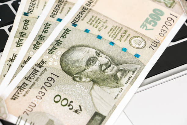 istock new indian 500 rupees banknotes and  laptop. 1168444927