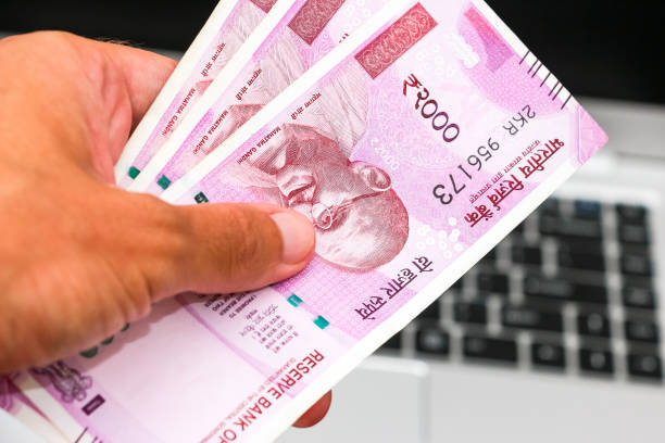 istock Hand holding brand new indian 2000 rupees banknotes 1168445495