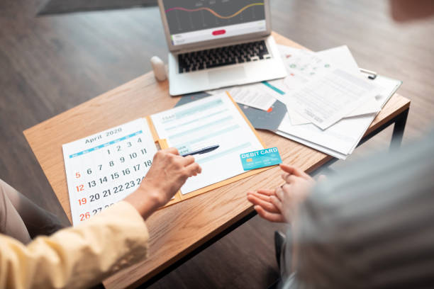 istock Two Caucasian businesswomen sitting and looking at documents 1168445712