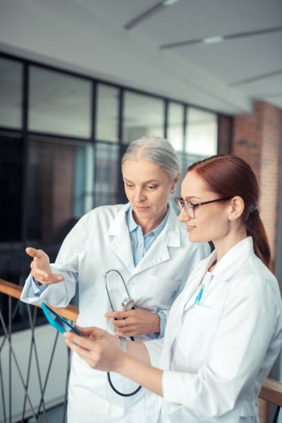 Senior woman with a stethoscope looking at the tablet screen