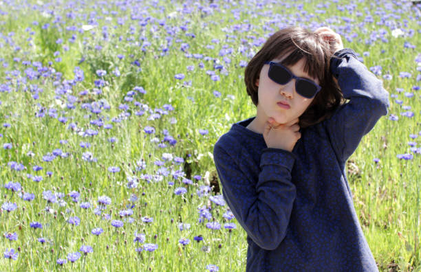 istock bored child scratching head having concerns over blooming floral field 1168446006
