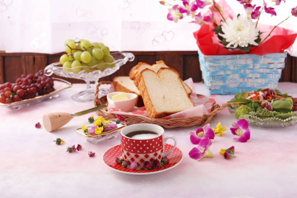 white kettle , beads, vintage jewelry boxes and flowers on a cream background
