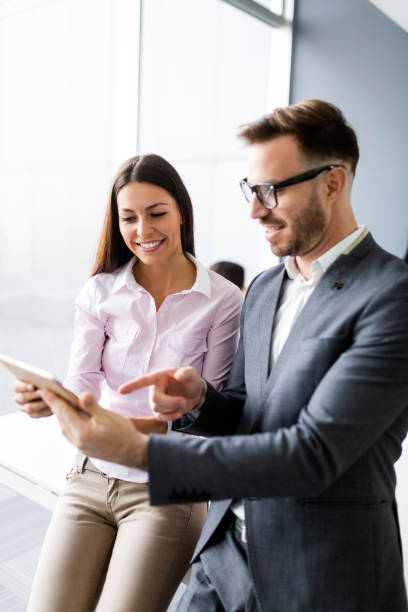 istock Happy young business colleagues in modern office 1168446098
