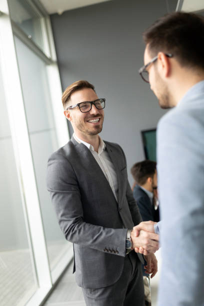 istock Two confident business man shaking hands during a meeting in the office 1168446101