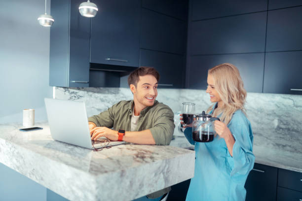 istock Girlfriend bringing coffee for her man working on laptop 1168446212