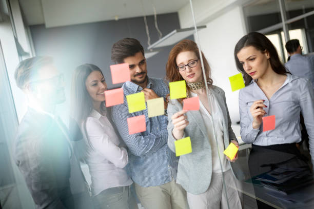 istock Confident business people reviewing project in office 1168446253