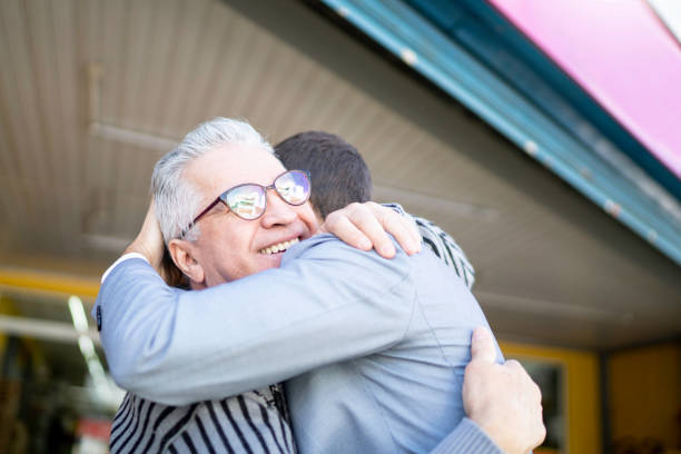 istock Senior and young man celebrating and embracing 1168447192
