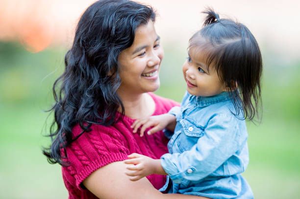istock Curious daughter in her mother's arms 1168447198