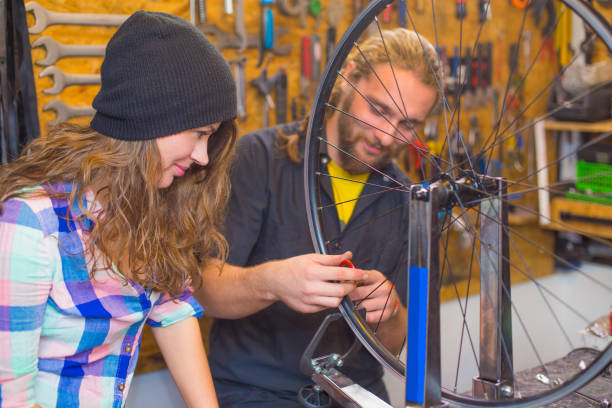 istock Young couple repairing bicycle in the workshop 1168449545