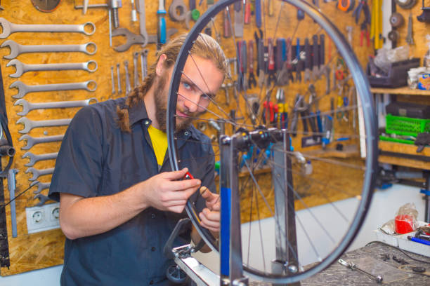 istock Blue eyed guy repairing bicycle in the workshop 1168449551