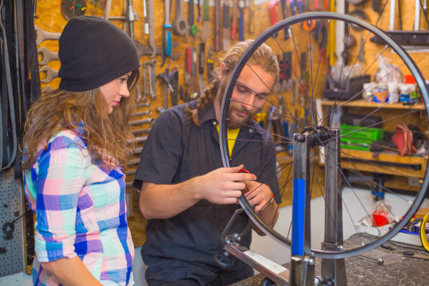 istock Young couple repairing bicycle in the workshop 1168449555