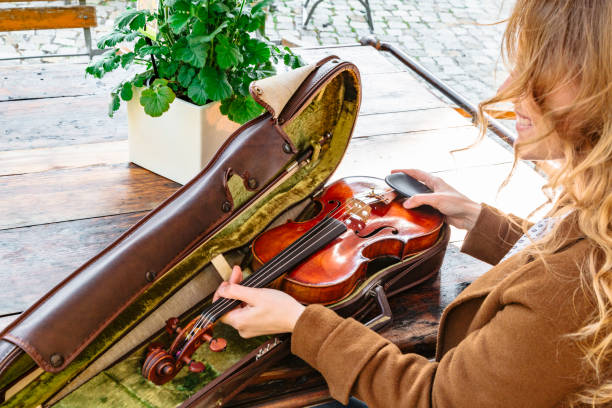 istock Womans hands holds old violin in case closeup 1168450633