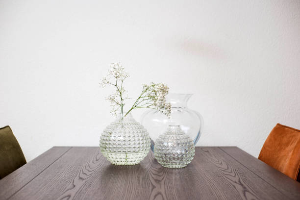 istock Vase with beautiful flowers on diner table, modern design luxury 1168451020
