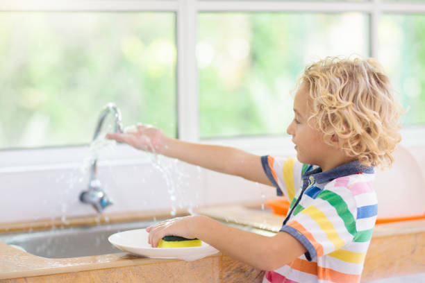 istock Child washing dishes. 1168451930
