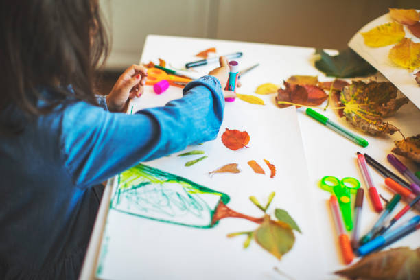 istock Children doing autumn handcrafts 1168452310
