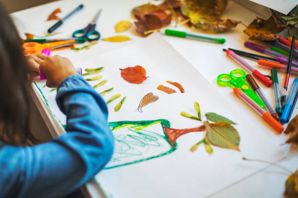 istock Children doing autumn handcrafts 1168453624