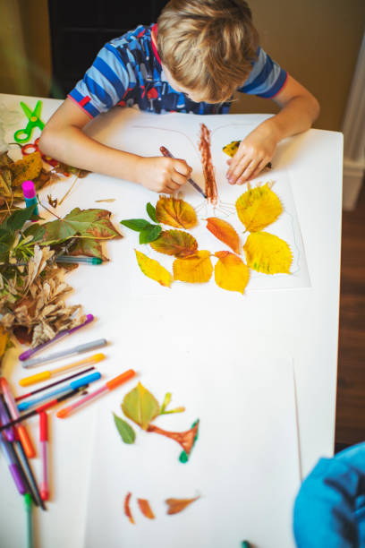 istock Children doing autumn handcrafts 1168454141