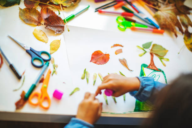 istock Children doing autumn handcrafts 1168454976