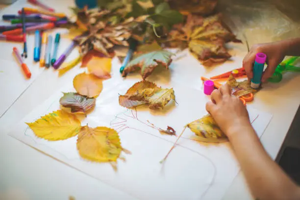 Children doing autumn handcrafts