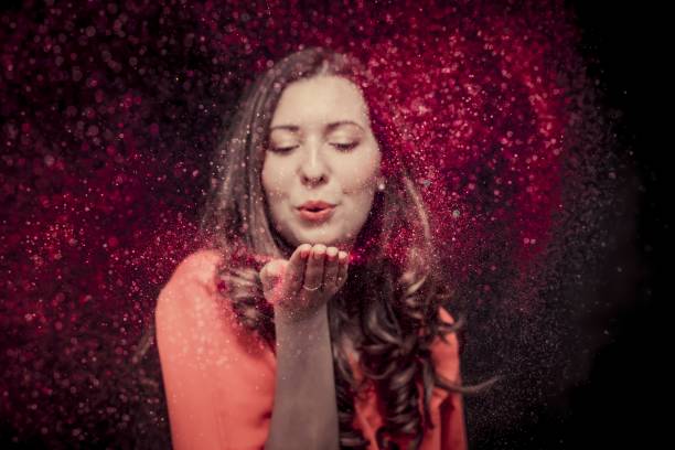 istock Colorful glitter blown by a young girl 1168457859