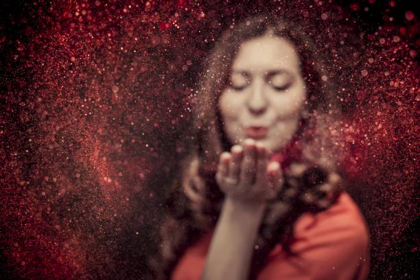 istock Colorful glitter blown by a young girl 1168457873
