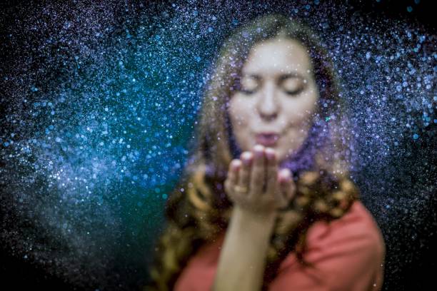 istock Colorful glitter blown by a young girl 1168457890