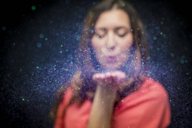 istock Colorful glitter blown by a young girl 1168457904