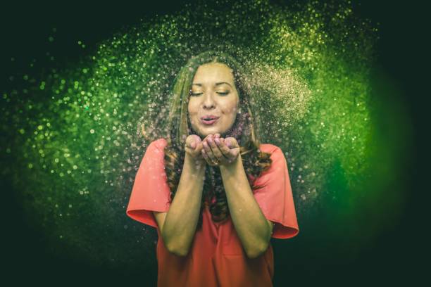 istock Colorful glitter blown by a young girl 1168457923