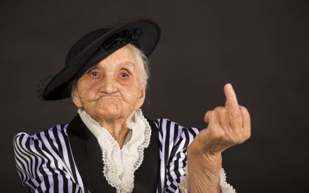 Old grandma in a white-black striped jacket Stylish old woman in black hat fame photos stock pictures, royalty-free photos & images