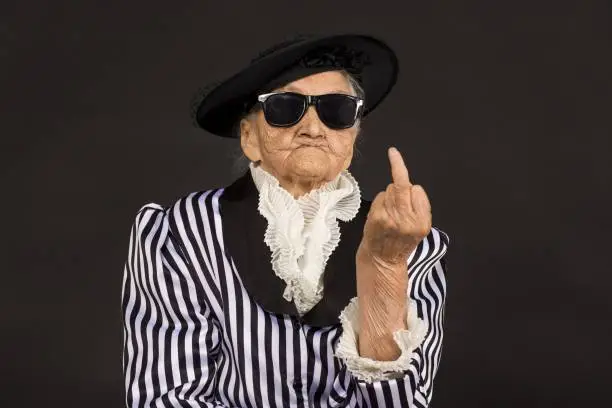 Photo of Old grandma in a white-black striped jacket