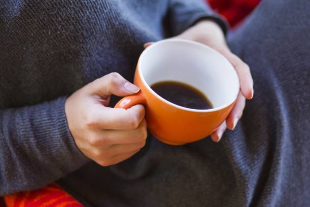 istock woman hands holding a cup of coffee 1168461275