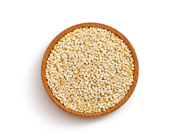 Wooden bowl of quinoa seeds isolated on white background, top view Wooden bowl of quinoa seeds isolated on white background with clipping path, close up, top view quinoa photos stock pictures, royalty-free photos & images