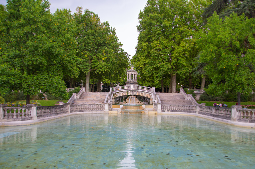 Dijon, France - July 25, 2014: Landscape view of the Darcy Park with its lake, fountain and trees at Dijon, Burgundy, France