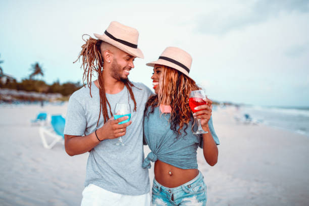 istock Latin Couple Drinking Cocktails At The Beach 1168462371