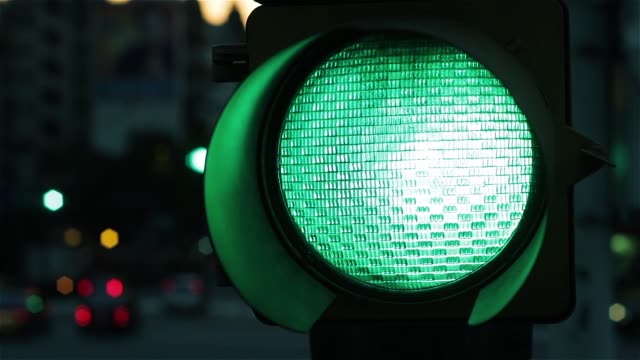 Green Traffic Light Signal At Night. Close-Up.