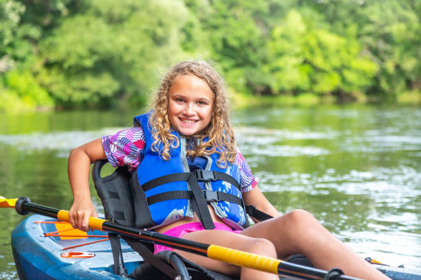 istock Young Girl Sitting in Kayak on River 1168465187