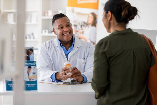istock Pharmacist smiles during discussion with pharmacy customer 1168467251