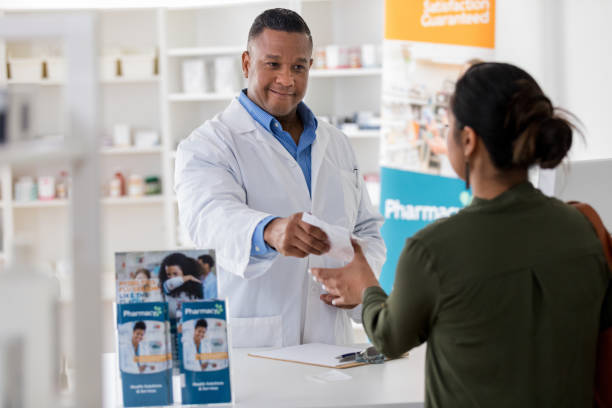 istock Confident pharmacist hands prescription to customer 1168467255