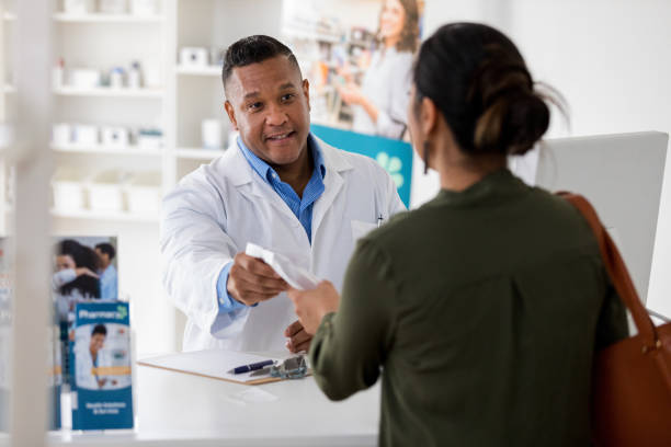 istock Pharmacist hands prescription to customer 1168467260