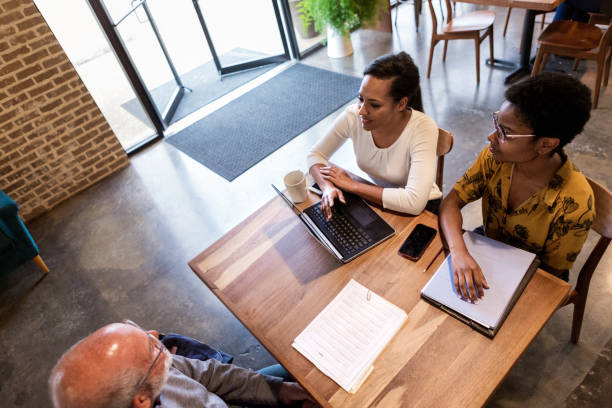 istock Strategy planning meeting with multi-ethnic group of co-workers at cafe 1168467324