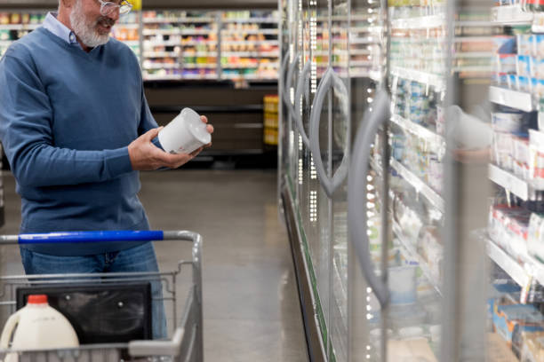 istock Mature adult man checks label on container 1168467378
