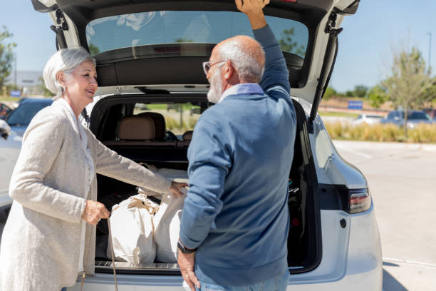 istock Husband and wife have pleasant conversation while loading groceries 1168467396